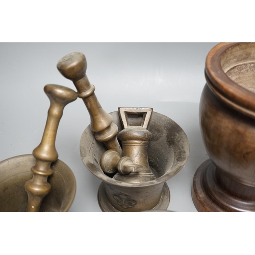 1385 - Three bell metal mortars, two pestles, a turned lignum vitae mortar and three postal weights, urn he... 