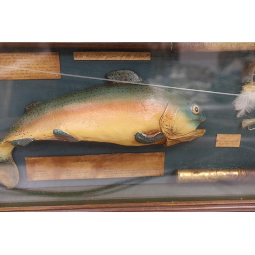 1402 - A cased fishing display case of a Rainbow Trout centred around angling ephemera, 106 x 34cm