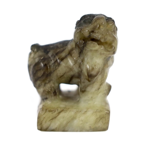 1594 - A Chinese pale celadon and black jade lion-dog seal, 18th/19th century, the creamy white stone wit... 