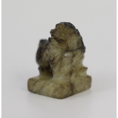 1594 - A Chinese pale celadon and black jade lion-dog seal, 18th/19th century, the creamy white stone wit... 