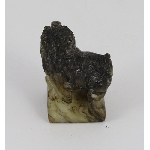 1594 - A Chinese pale celadon and black jade lion-dog seal, 18th/19th century, the creamy white stone wit... 