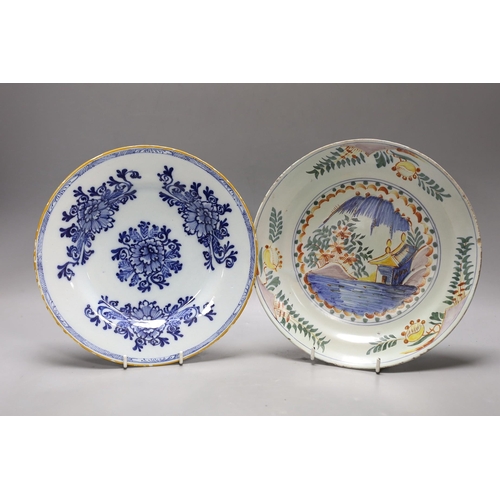 1602 - An early 18th century Delft polychrome dish and a mid 18th century Delft blue and white plate, large... 