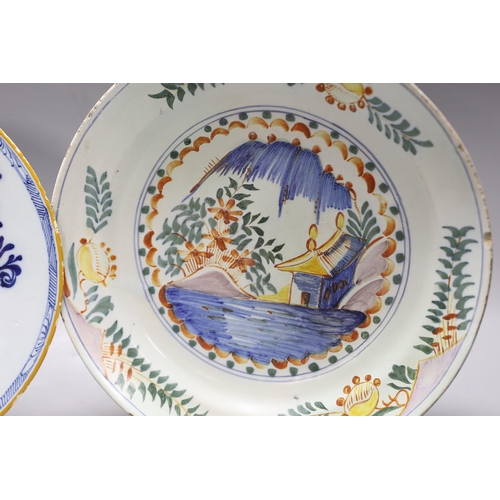 1602 - An early 18th century Delft polychrome dish and a mid 18th century Delft blue and white plate, large... 