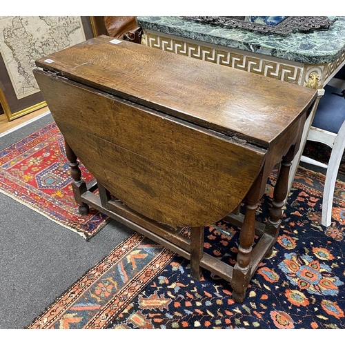 108 - An 18th century oak oval topped gateleg table, width 124cm extended, depth 90cm, height 74cm