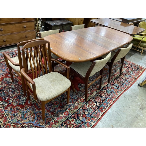 22 - A mid century teak extending dining table, length 214cm extended, one spare leaf, width 108cm, heigh... 