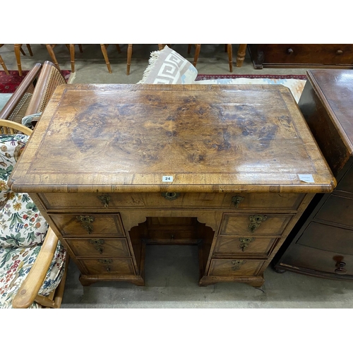 24 - A George II feather banded walnut kneehole desk, length 99cm, depth 57cm, height 88cm