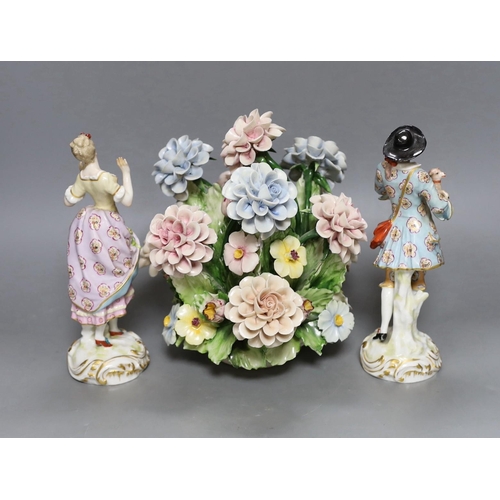 250 - A pair of Continental porcelain figures and a Naples flowers bouquet. 22cm tall