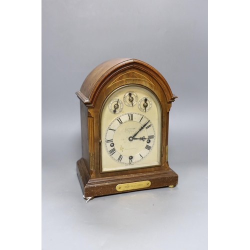 251 - A George V inlaid walnut lancet shaped chiming mantel clock, with German movement and 15th July 1914... 