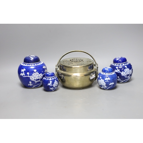 260 - A Chinese bronze hand warmer and four Chinese blue and white Prunus jars and covers. Tallest 12cm... 