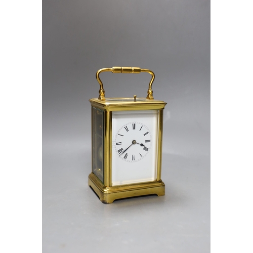 264 - A French brass repeating carriage clock. 18cm tall