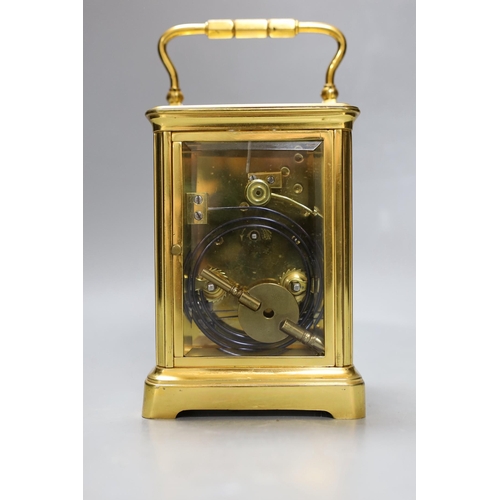 264 - A French brass repeating carriage clock. 18cm tall