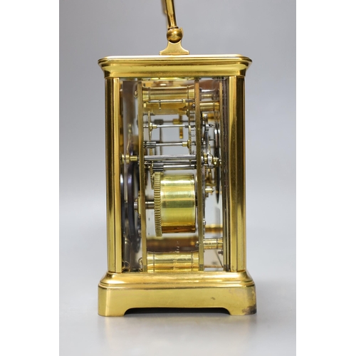 264 - A French brass repeating carriage clock. 18cm tall