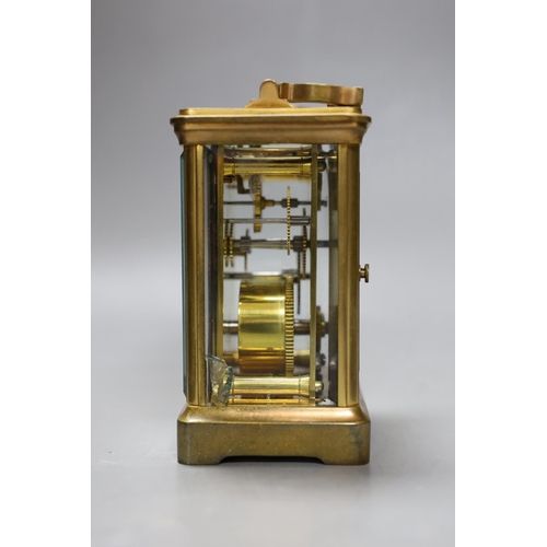 266 - A leather cased brass carriage timepiece. 13cm tall