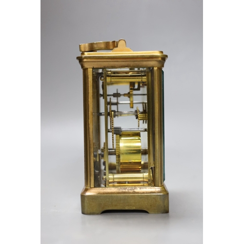 266 - A leather cased brass carriage timepiece. 13cm tall