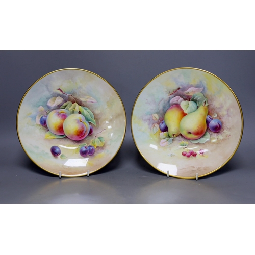 280 - A pair of Minton fruit painted plates, signed A. Holland, 23cm diameter, together with two books on ... 