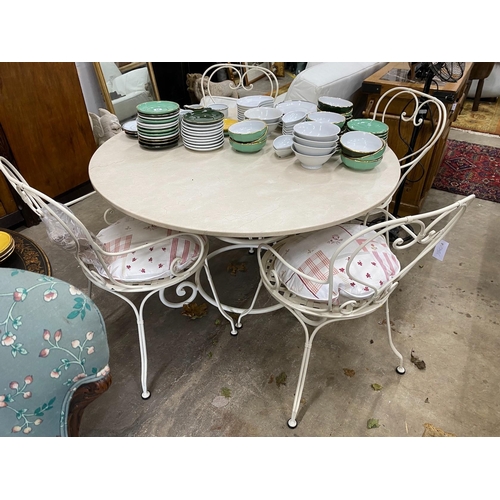 29 - A circular reconstituted marble garden table, diameter 120cm, height 74cm and four painted wrought i... 