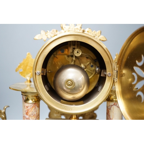 299 - A French gilt metal and marble clock garniture, 38cm