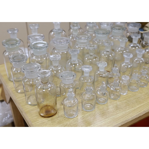 306 - A large collection of clear glass chemist's bottles