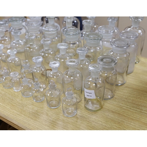 306 - A large collection of clear glass chemist's bottles