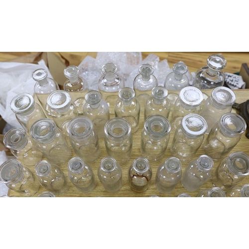 306 - A large collection of clear glass chemist's bottles