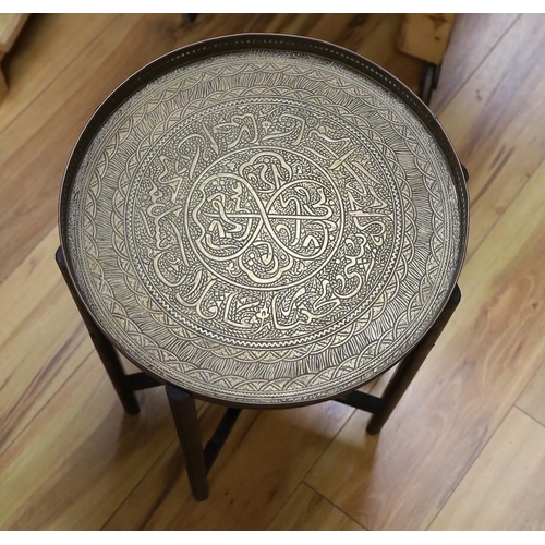 311 - Benares brass folding table on wooden stand, 52cm tall, together with a three-footed lion pawed coal... 