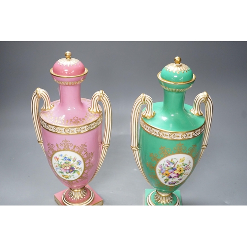 316 - A pair of Coalport Coalbrookdale two handled vases with central oval panelled floral painting and gi... 