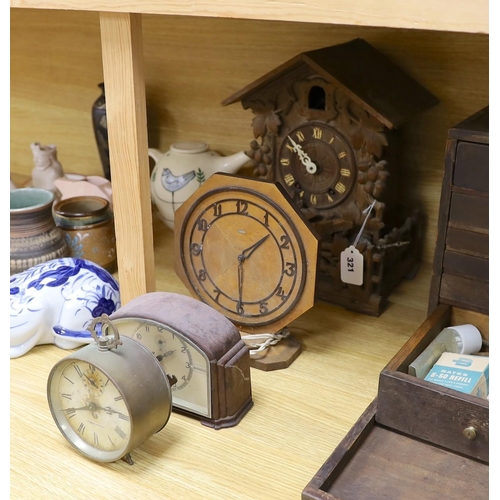 321 - A Black Forest cuckoo clock, together with another octagonal faced timepiece, a Bakelite timepiece a... 