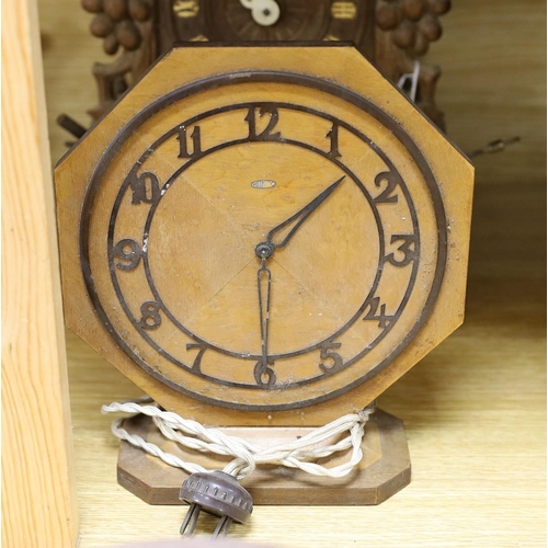 321 - A Black Forest cuckoo clock, together with another octagonal faced timepiece, a Bakelite timepiece a... 