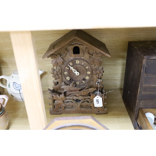 321 - A Black Forest cuckoo clock, together with another octagonal faced timepiece, a Bakelite timepiece a... 