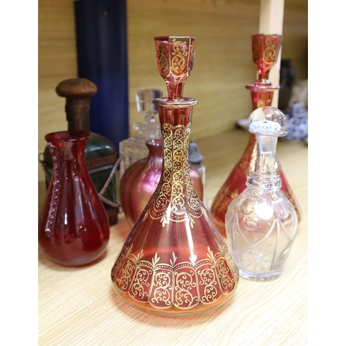 323 - A pair of Bohemian gilded ruby glass decanters and stoppers, a Bohemian millefiori paperweight sto... 