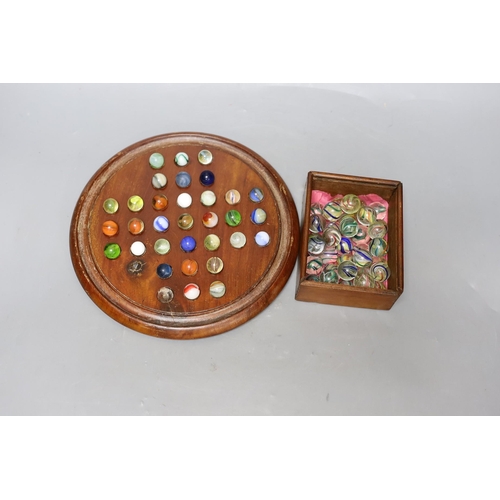 331 - A mahogany solitaire board and marbles