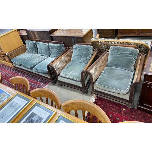 34 - An early 20th century mahogany single caned three piece bergere suite, settee length 182cm, depth 77... 