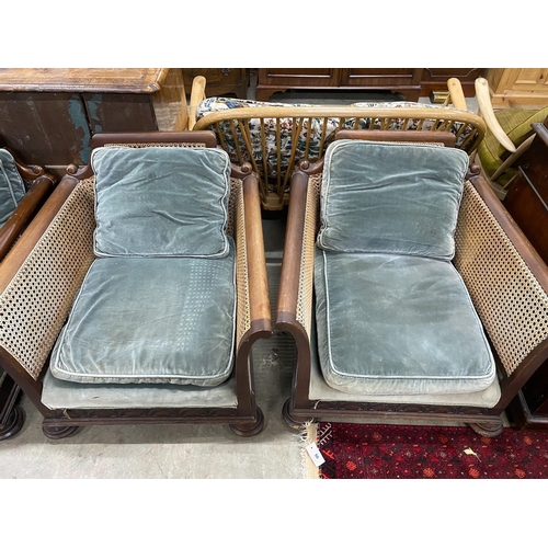 34 - An early 20th century mahogany single caned three piece bergere suite, settee length 182cm, depth 77... 