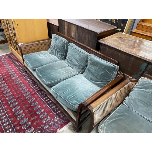 34 - An early 20th century mahogany single caned three piece bergere suite, settee length 182cm, depth 77... 