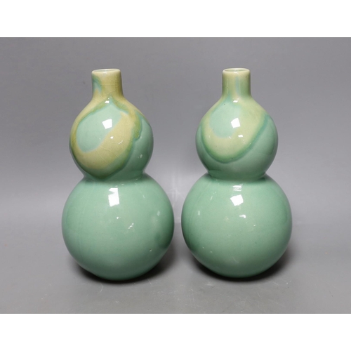 344 - A pair of Chinese celadon ground bottle vases 21cm tall