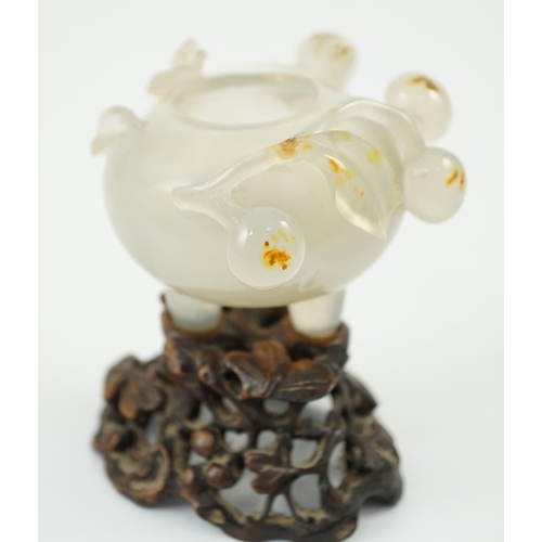 348 - A Chinese small carved agate brushwasher on wooden stand, 19th century