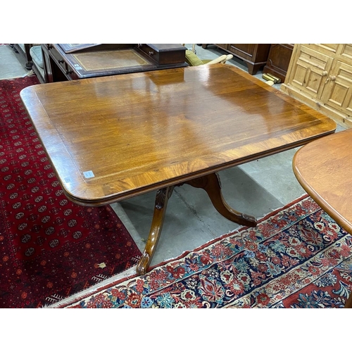 37 - A Regency banded mahogany rectangular tilt top dining table, length 141cm, depth 106cm, height 75cm... 