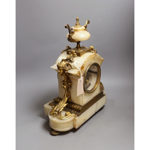 391 - A late 19th century French ormolu mounted alabaster mantel clock. 42cm tall