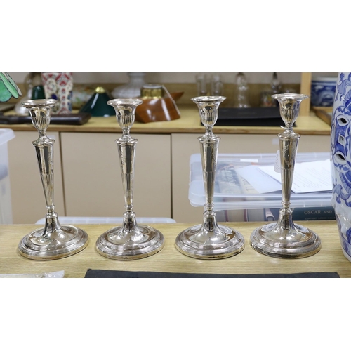 394 - A set of four 19th century silver plated candlesticks. 29cm