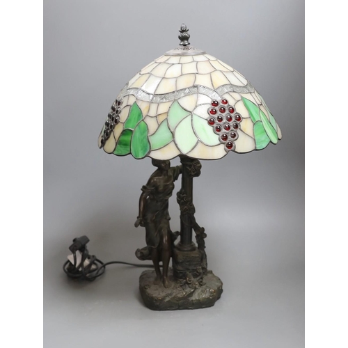 395 - A figural table lamp with Tiffany style shade 47cm