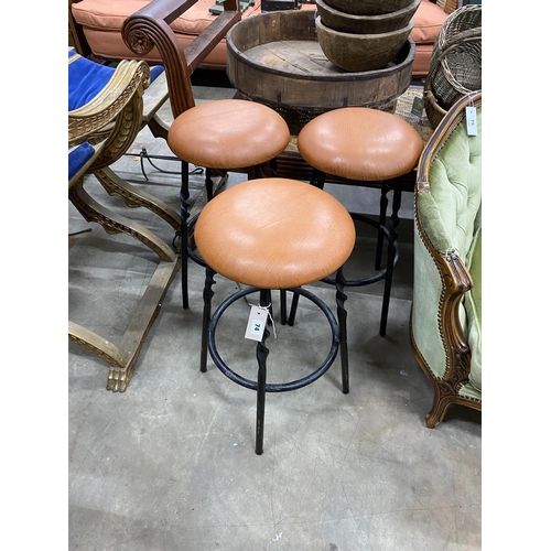 41 - A set of three wrought iron and tan leather stools, height 64cm