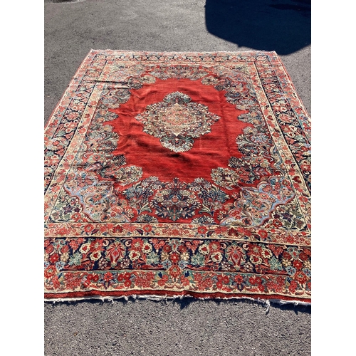 42 - A large North West Persian red ground carpet, 361cm x 274cm