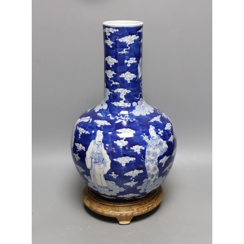 440 - A Chinese blue and white figural vase on hardwood stand, 40cm total height