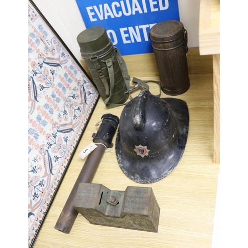 441 - A WW2 gas mask in original metal case, together with other related ephemera, including an enamelled ... 