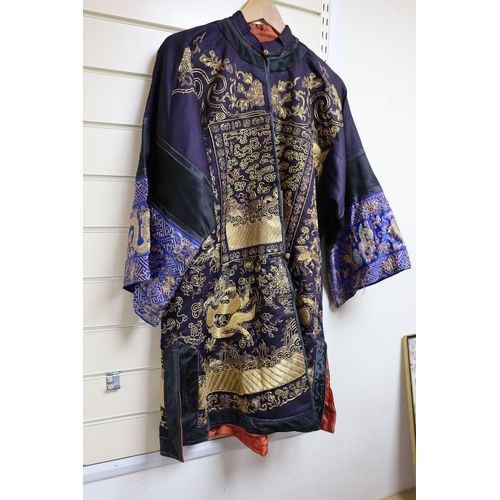 443 - A 20th century Chinese robe, decorated with navy ground and gilt thread all over five claw dragons... 