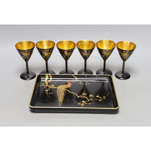 454 - A set of six Japanese lacquer cocktail or liqueur cups and a similar tray