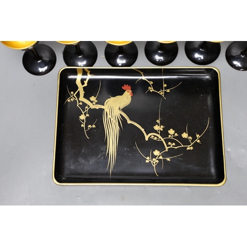 454 - A set of six Japanese lacquer cocktail or liqueur cups and a similar tray