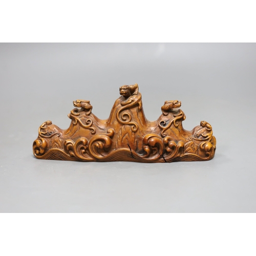 480 - A Chinese carved wood brush rest, 18cms wide