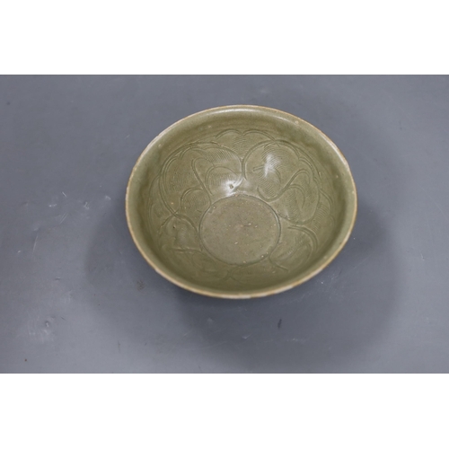 487 - A Chinese carved Yaozhou celadon bowl, Northern Song Dynasty, 15.5cms high