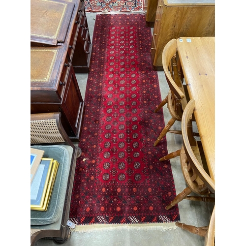 50 - A Bokhara red ground runner 290cms x 85cms